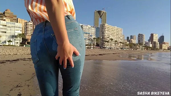 Wet shoot on a public beach with Crazy Model. Risky outdoor masturbation. Foot fetish. Pee in jeans.